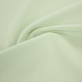 A swirled sample of ecotechflex recycled polyester spandex in the color neo mint.
