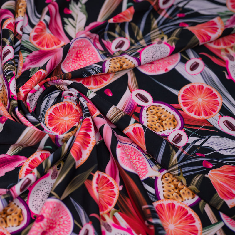 A swirled piece of Exotic Sliced Fruit Printed Spandex.
