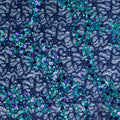 A flat sample of exotic stretch lace sequin in the color navy-purple.