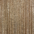 A flat sample of exquisite stretch mesh sequin in the color light gold available at blue moon fabrics.