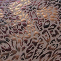 A flat sample of fierce foil printed spandex in the color burgundy-tan.