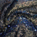 A swirled sample of flirt stretch mesh sequin in the color black.