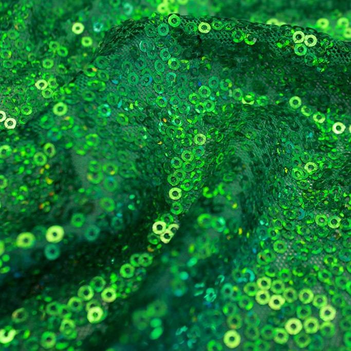 A swirled sample of flirt stretch mesh sequin in the color kelly green.