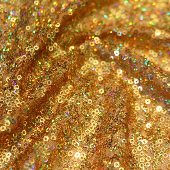 A swirled sample of flirt stretch mesh sequin in the color gold.