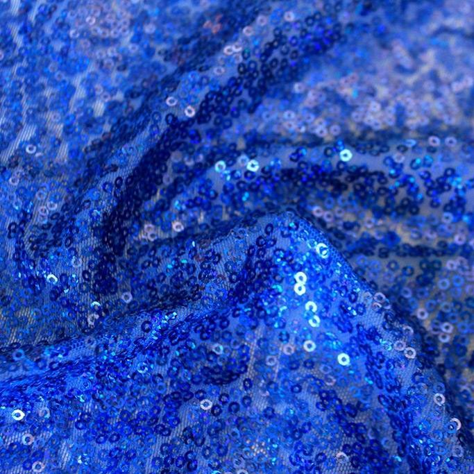 A swirled sample of flirt stretch mesh sequin in the color royal.