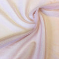 A swirled sample of foiled stretch mesh in the color blush-gold.