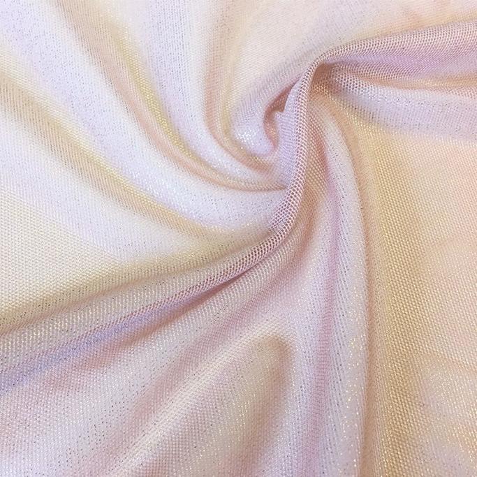 A swirled sample of foiled stretch mesh in the color blush-gold.
