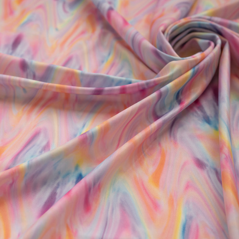 A close up of a swirled sample of Tie-Dye Swirl Foil Printed Spandex.