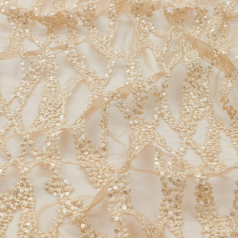 A flat sample of forget me not embroidered mesh in the color champagne.