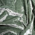 A crumpled pieces of Frozen Crushed Stretch Velvet in the color sage green