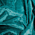 A crumpled pieces of Frozen Crushed Stretch Velvet in the color teal green