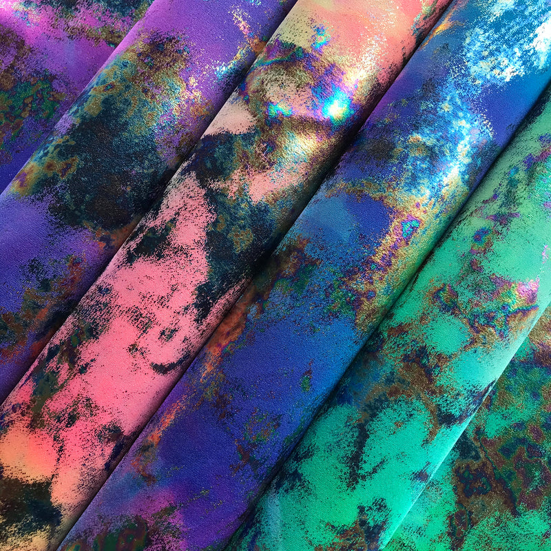 A flat sample of funky clouds foil printed spandex in all available colors.