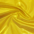A swirled sample of glaze foiled stretch mesh in the color gold.