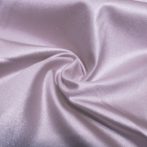 A swirled piece of nylon spandex fabric with an all over shiny look in the color grape mist.