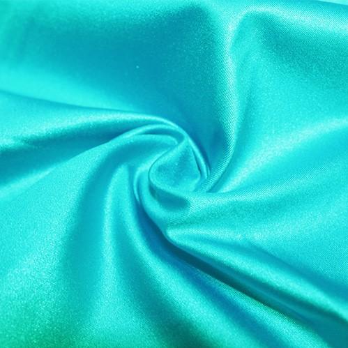 A swirled piece of nylon spandex fabric with an all over shiny look in the color mali.