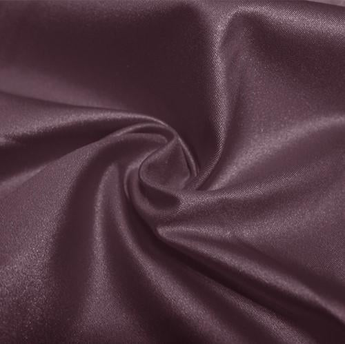 A swirled piece of nylon spandex fabric with an all over shiny look in the color toasted mauve.