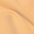 A flat sample of flexfilt recycled polyester spandex in the color apricot.