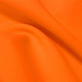 A flat sample of flexfilt recycled polyester spandex in the color tropical tangerine.