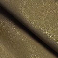 A flat sample of glitz shiny spandex in the color dust/gold.
