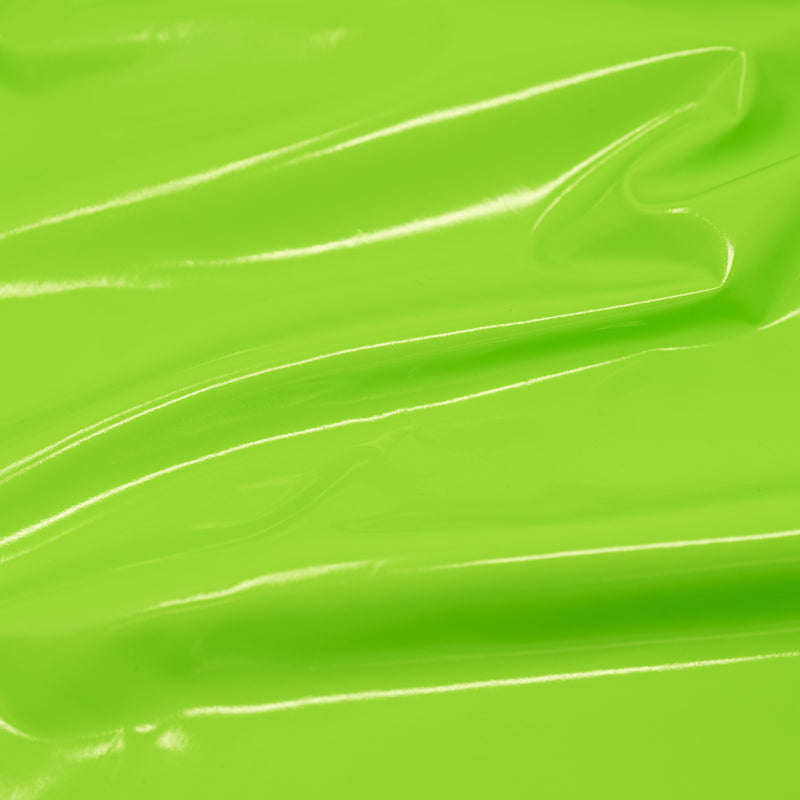 A swirled piece of polyurethane coated polyester spandex in the color Neon-Lime