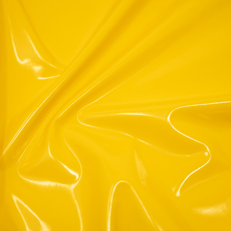 A swirled piece of polyurethane coated polyester spandex in the color Rain Slick Yellow