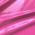 A swirled piece of polyurethane coated polyester spandex in the color hot pink.