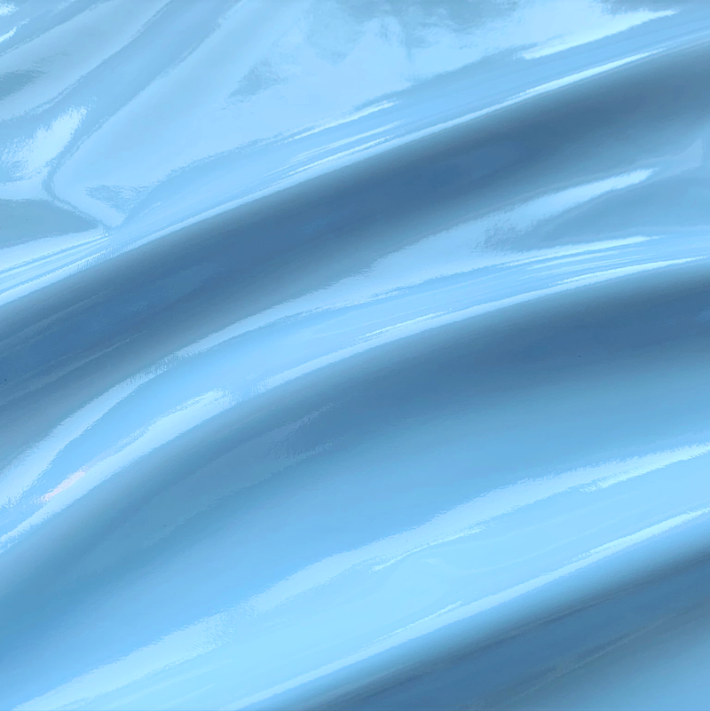 A swirled piece of polyurethane coated polyester spandex in the color light blue.