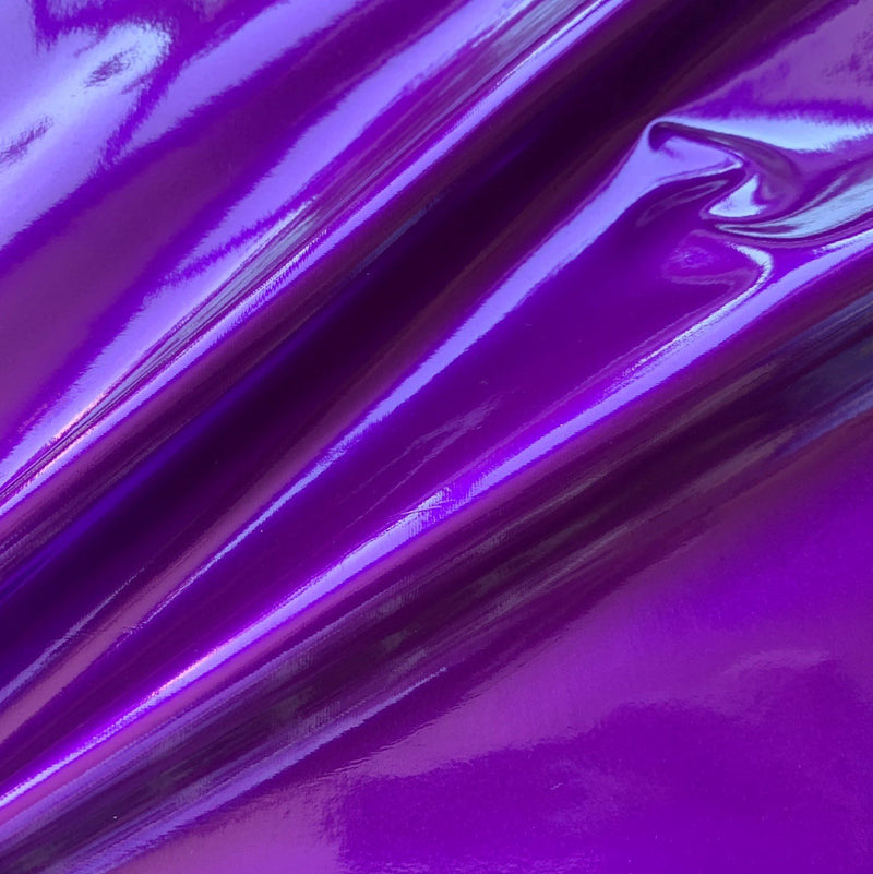 A swirled piece of polyurethane coated polyester spandex in the color purple.