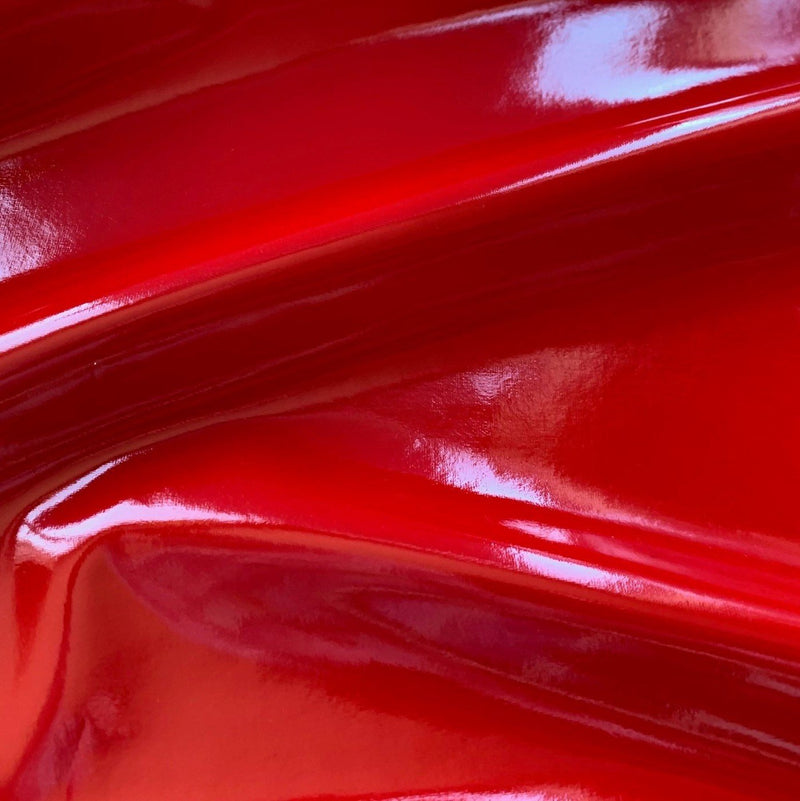 A swirled piece of polyurethane coated polyester spandex in the color red.