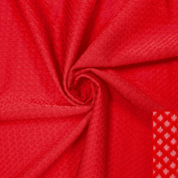 A swirled piece of Hive Textured Spandex in the color red.