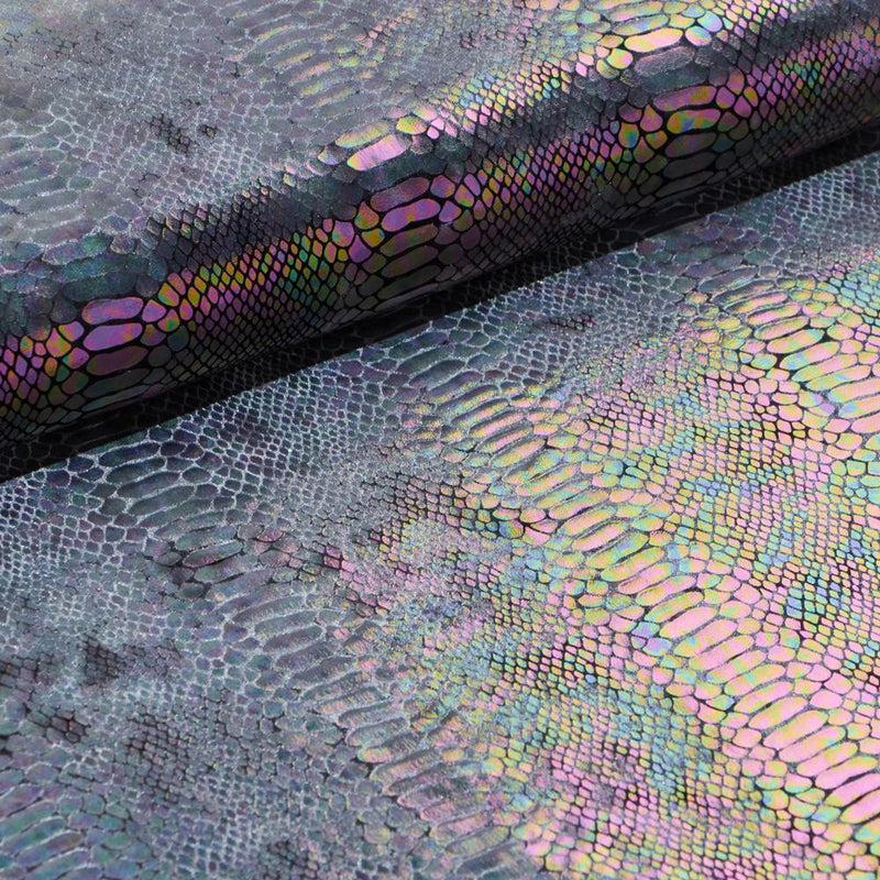 A folded sample of illusion anaconda foil printed stretch velvet in the color charcoal.