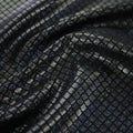 A swirled sample of illusion foil printed spandex in the color black-black.