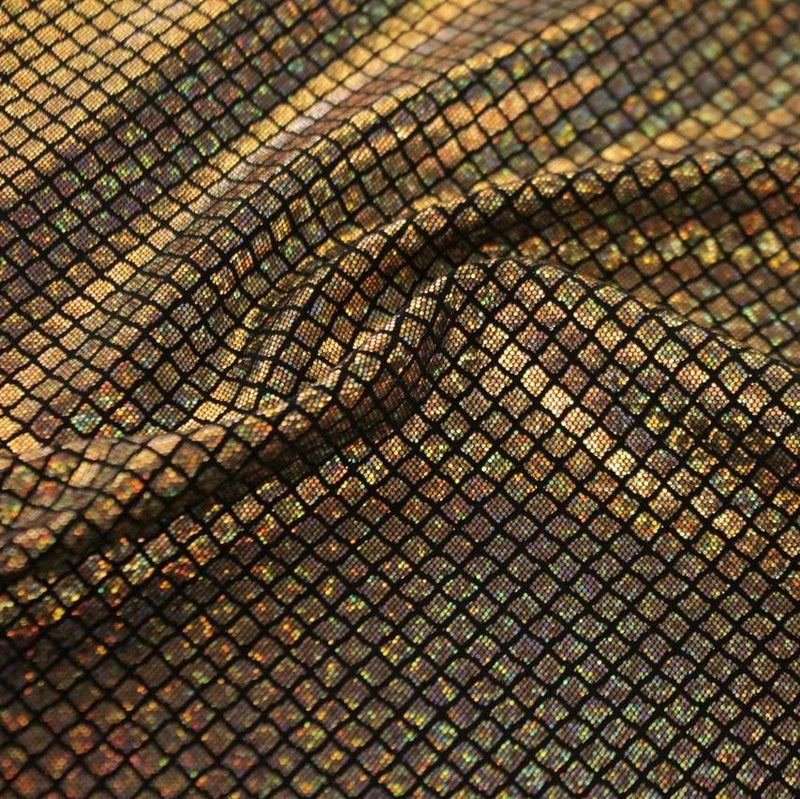 A swirled sample of illusion foil printed spandex in the color black-gold.