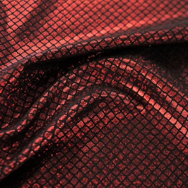 A swirled sample of illusion foil printed spandex in the color black-red.
