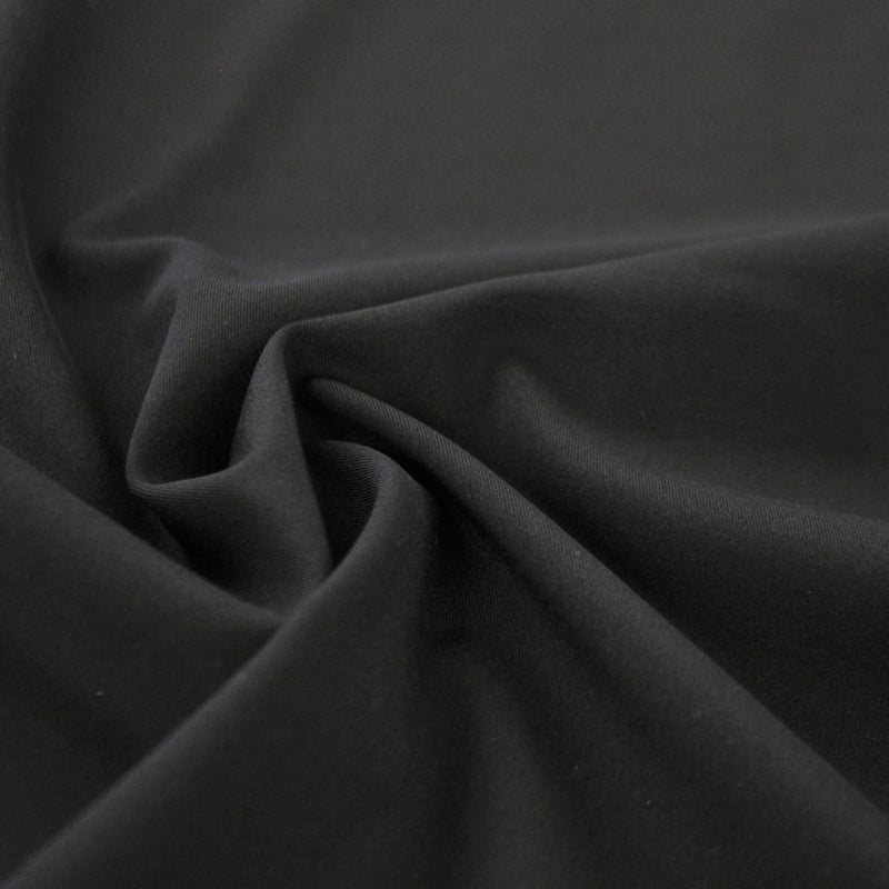 Swirled piece of Indulge Micro Nylon Spandex in the color black