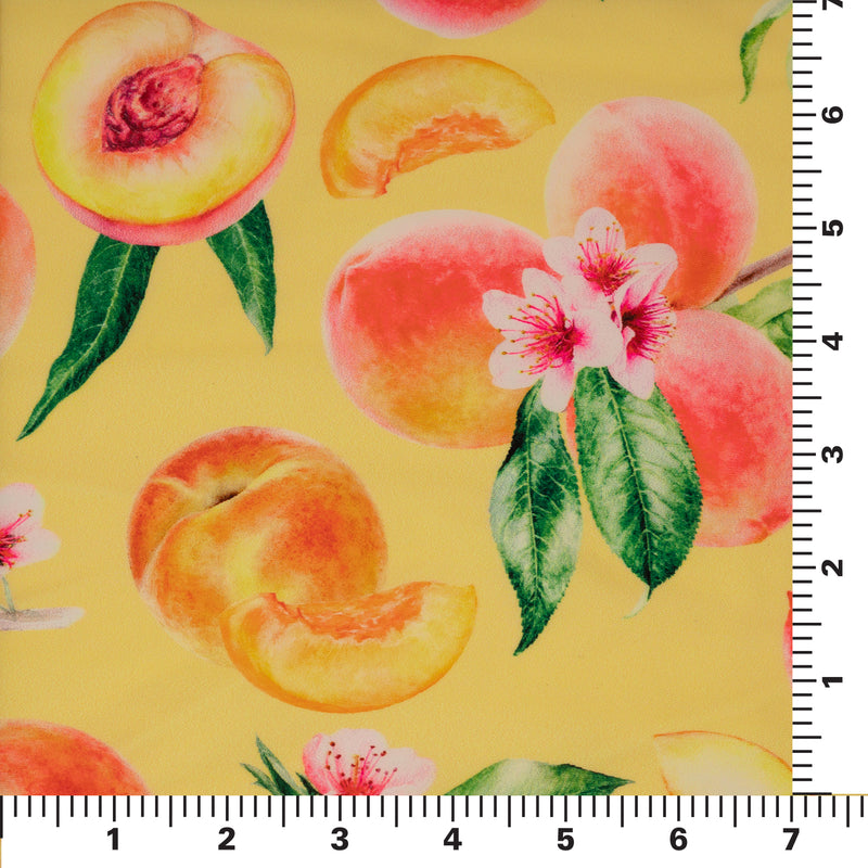 Flat sample shot on a 7"x7" ruler of It's All Peachy Printed Spandex Fabric. The print is of whole peach clusters with pink peach blossoms and green leaves, whole individual peaches with peach slices and peach halves on a yellow toned background.  