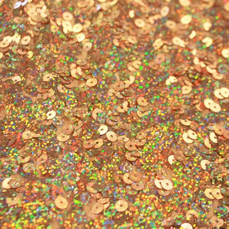 A flat sample of jazzy stretch sequin in the color gold.