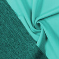 A swirled piece of Karma Double-Sided Heather Spandex in the color aqua tides.