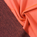 A swirled piece of Karma Double-Sided Heather Spandex in the color neon coral.