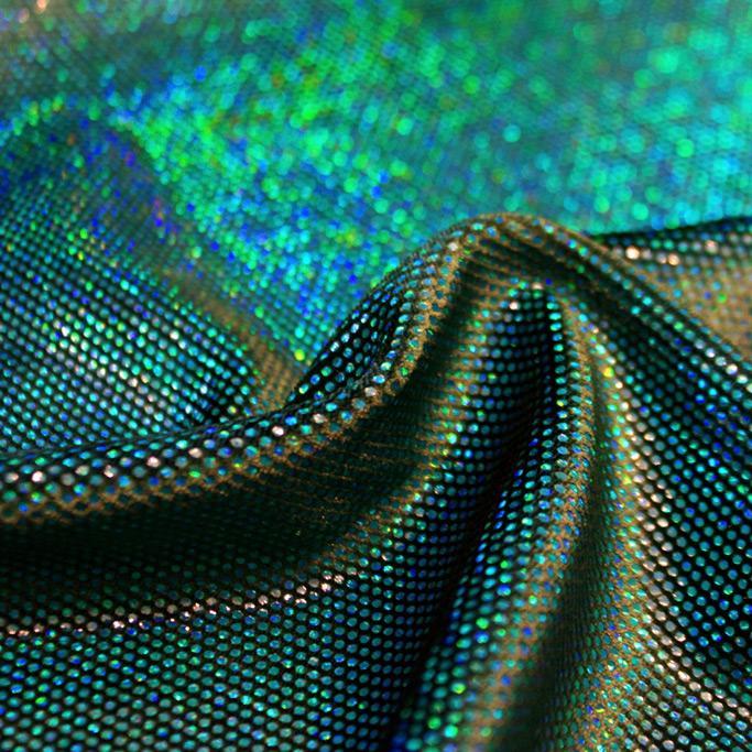 A swirled sample of legacy foiled stretch velvet in the color emerald green.