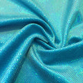 A swirled sample of legacy foiled stretch velvet in the color turquoise.