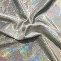 A swirled sample of legacy foiled stretch velvet in the color silver.