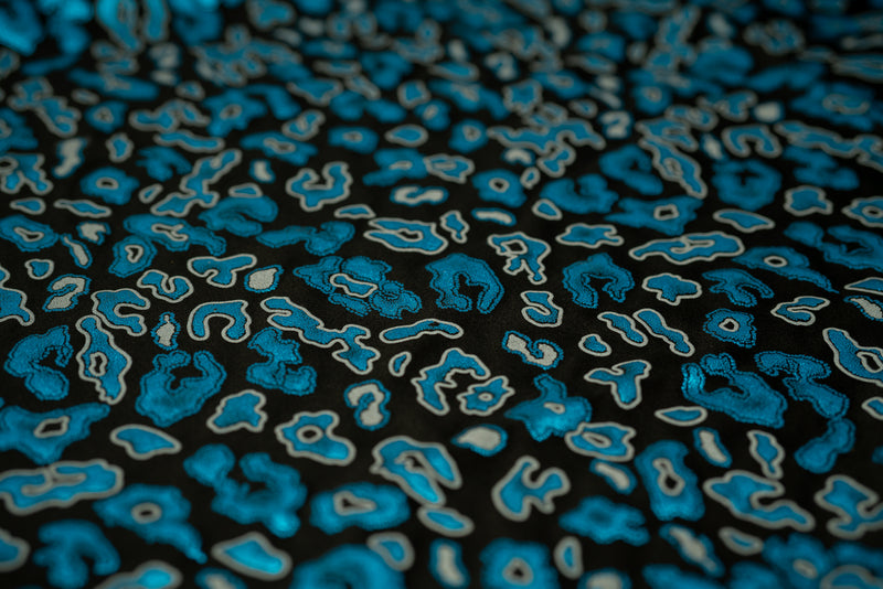 Detailed shot of Leo Party Foil Printed Spandex in color Black/Turquoise.