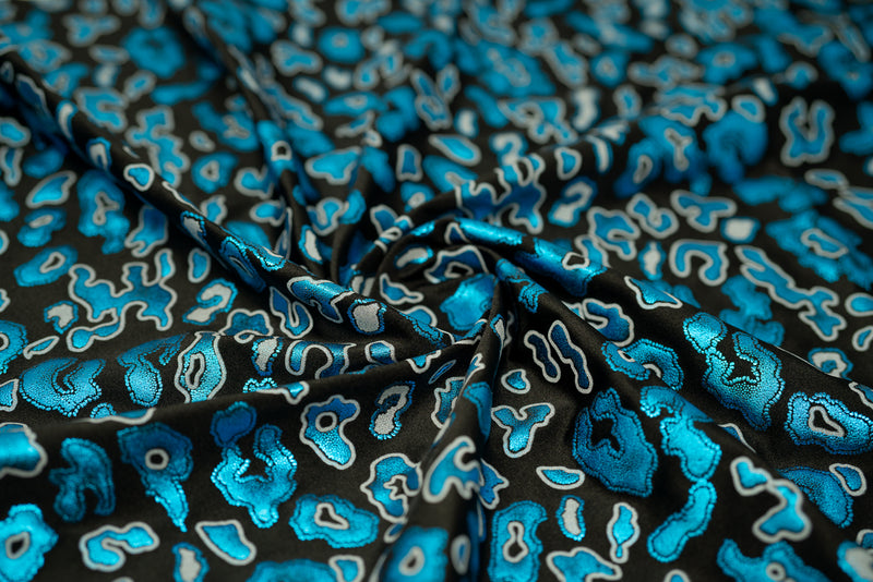 Detailed shot of Leo Party Foil Printed Spandex in color Black/Turquoise.
