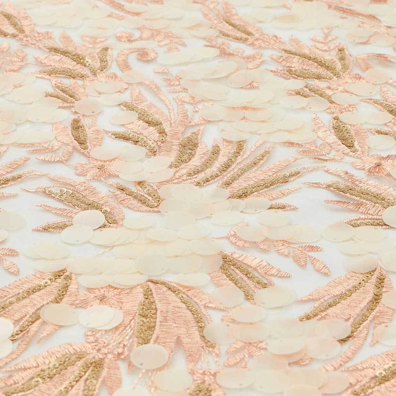 A flat sample of luscious embroidered mesh in the color coral-nude.