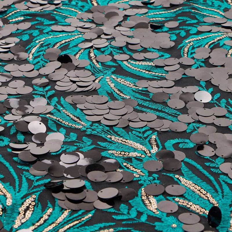 A flat sample of luscious embroidered mesh in the color teal-black.
