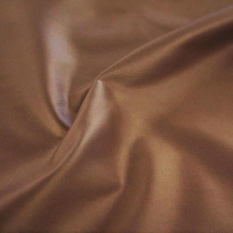 A swirled sample of luster soft foiled spandex in the color gold.