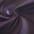 A swirled sample of luster soft foiled spandex in the color haze. 