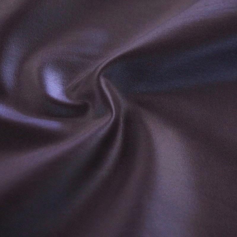 A swirled sample of luster soft foiled spandex in the color haze. 
