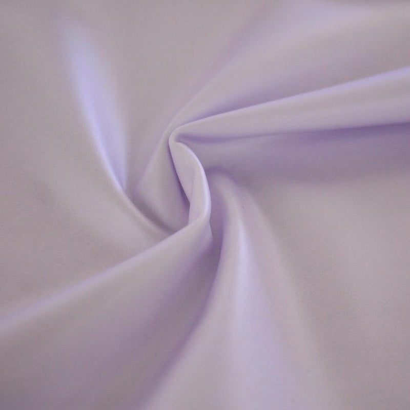 A swirled sample of luster soft foiled spandex in the color lilac.